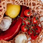 handbag with fresh assorted vegetables on table