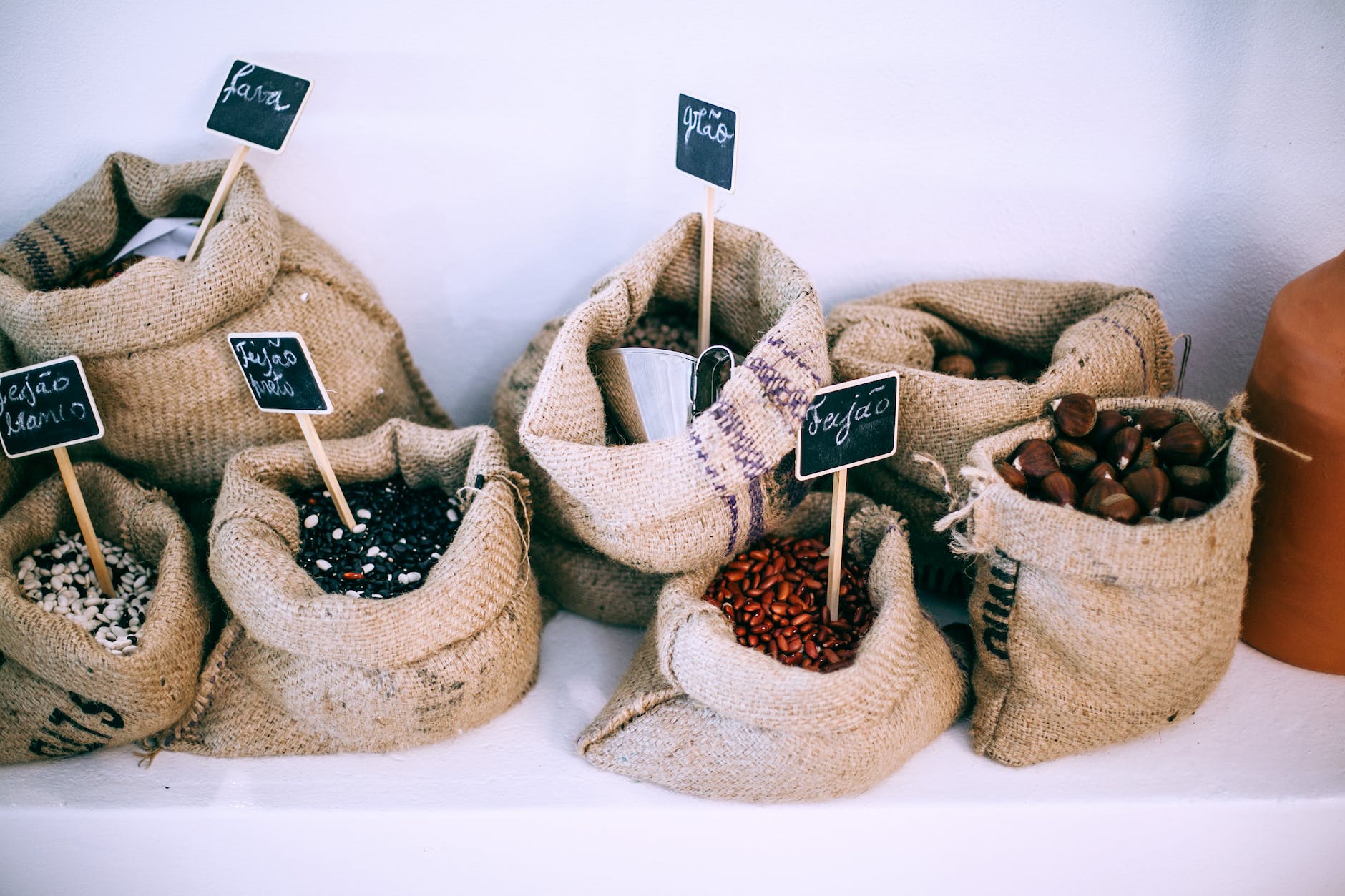 different types of beans in sacks with inscriptions