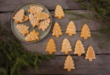 brown christmas tree shaped gingerbread cookies on wood background