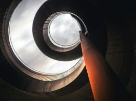 low angle photography of concrete spiral stairs