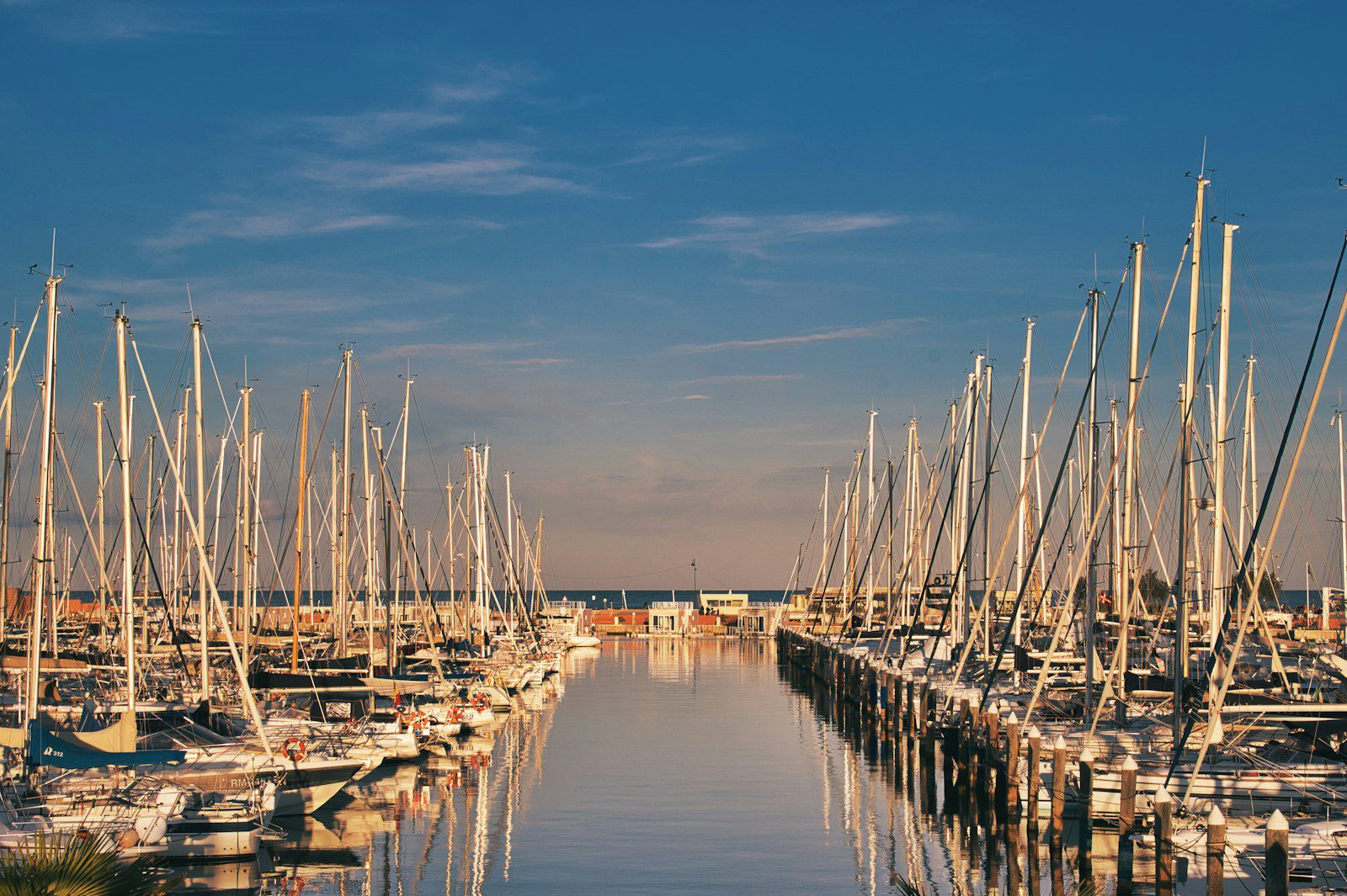 a harbor filled with lots of boats under a blue sky