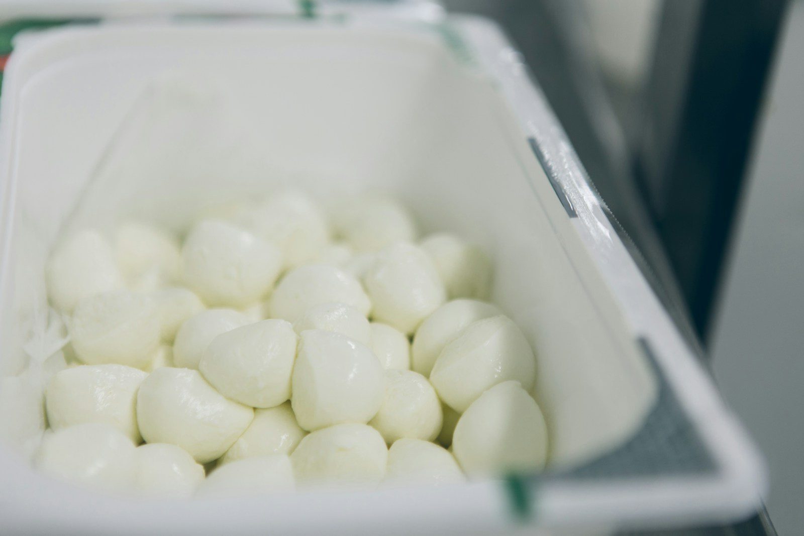 a container filled with white marshmallows sitting on top of a counter